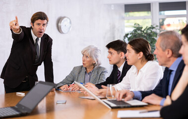 Fototapeta premium Dissatisfied boss gave dressing down to team of top managers in the office