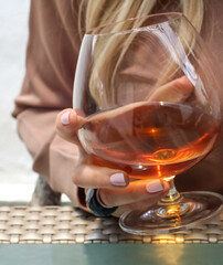.Elegant Female Hand with a Glass of Rum or whisky.Elegant Female Hand with a Glass of Rum or whisky.Elegant Female Hand with a Glass of Rum or whisky.