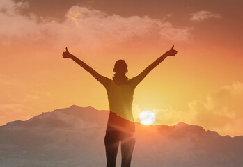 Fototapeta premium Happy young woman smiles watches the sunset over the mountains with feelings of joy, happiness and peace 