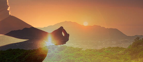 hand closeup of woman practicing yoga in nature sunset 
