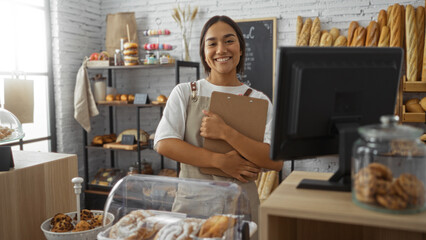 Young, woman, brunette, adult, standing, smiling, inside, bakery, holding, clipboard