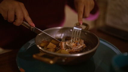 Woman eating traditional dish with fork and knife in cozy italian restaurant.