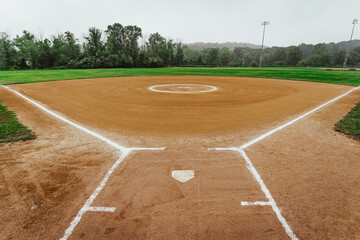 a dirt baseball field view from behind home plate