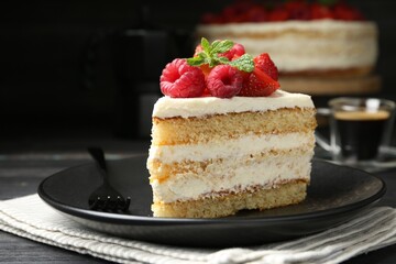 Piece of tasty sponge cake with fresh berries and mint served on black table, closeup