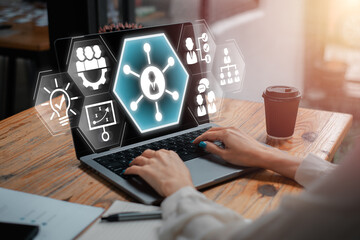 Hands typing on a laptop with digital icons representing soft skills like teamwork, communication, and leadership.