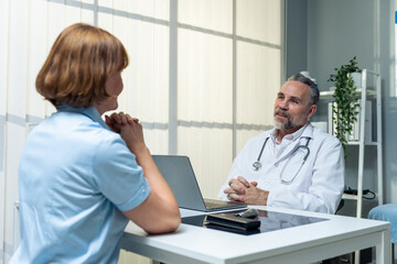Caucasian senior woman visit and consult health problem with doctor. 