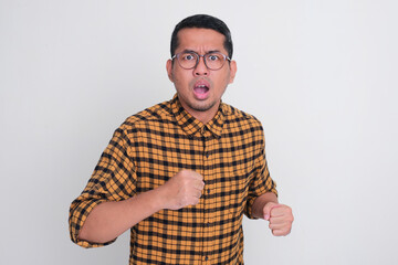 Adult Asian man running towards camera with worried expression