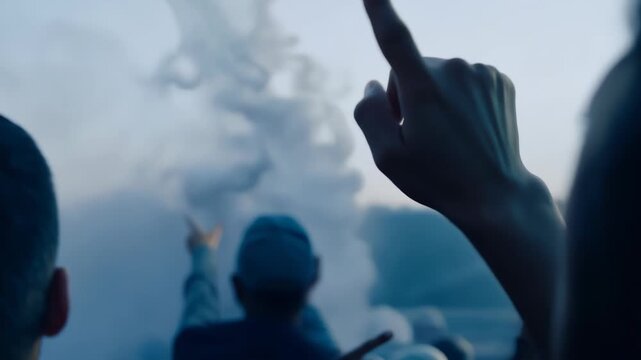 Close-up shot: Silhouetted spectators react with amazement against a cloudy sky backdrop. Camera focuses on wide-eyed expressions and pointing gestures.