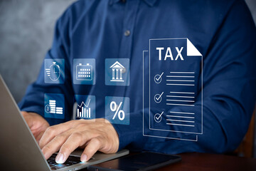 E-tax, Taxpayer using laptop filling out tax forms online for tax payment.