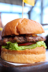 Cheeseburger With Salad And Tomato On a wooden board 