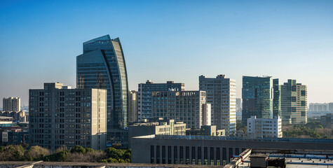 Obraz premium Modern Skyline Silhouette Against Blue Sky