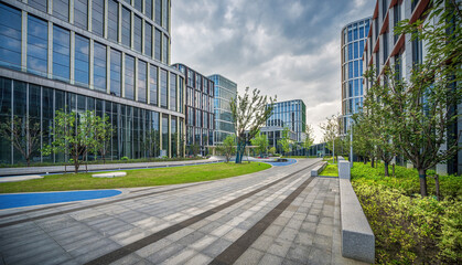Fototapeta premium Glass Office Buildings and Curved Waterway in Urban Park