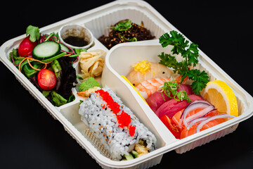 6 pieces of Spicy Tuna, 5 pieces of Small Dynamite, 4 pieces of Potato California roll, salad, and japchae