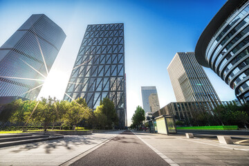 Modern City Skyline with Sunburst on Clear Day