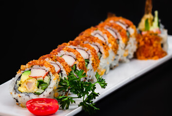 Dynamite roll topped with spicy tuna