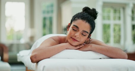 Spa, relax, and woman on bed with massage for .aromatherapy, happiness or luxury treatment. Wellness, lying and female person with eyes closed for stress relief, muscle reflexology or holistic detox
