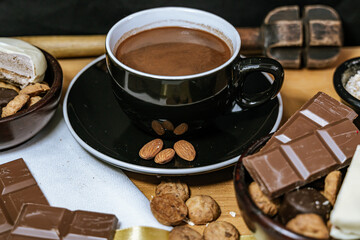 Chocolate chip cookies, dark and white chocolate bar, small bowl of oatmeal and nuts. International Chocolate Day.