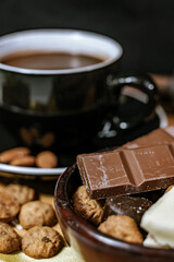 Chocolate chip cookies, dark and white chocolate bar, small bowl of oatmeal and nuts. International Chocolate Day.
