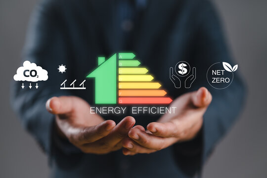 Energy efficiency concept. Person holding energy efficiency rating icon on virtual screen for energy efficient house building rate label audit.