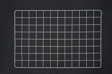 White wire grid wall on black background isolated