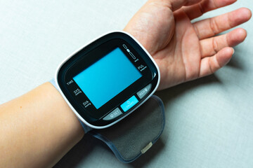 Man checks blood pressure monitor and heart rate monitor with digital pressure gauge. Health care and Medical concept