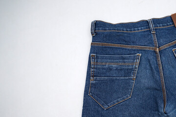 Pocket detail of classic blue denim jeans on white isolated background