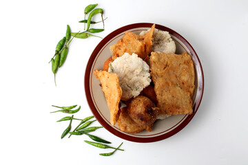 Indonesian fried foods. traditional street food made from flour, vegetables, tofu, tempeh etc and served with green chili. with copy space. fried food, isolated