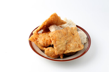 Indonesian fried foods. traditional street food made from flour, vegetables, tofu, tempeh etc and served with green chili. with copy space. fried food, isolated
