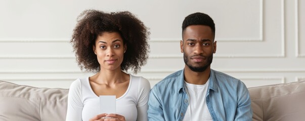 Emotional Struggle of Fertility: Couple on Sofa Reacting to Positive Pregnancy Test with Tears and Distress, Concept of Impending Motherhood
