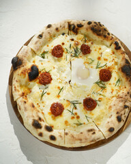 Decadent pizza with a rich sauce, melted cheese, and a perfectly cooked egg