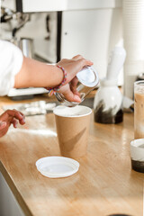 Preparation of iced coffee, close-up of hands