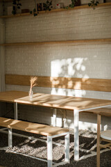 shot of an empty cafe's brown and white furniture at noon