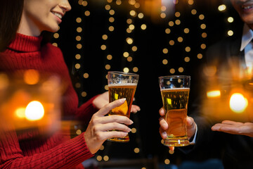 food and drink male friends are happy drinking beer and clinking glasses at a bar or pub.