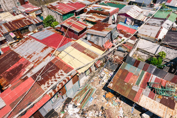 Aerial of densely packed and small shanty houses with shoddy construction at a squatter colony in Metro Manila.