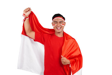 Indonesian man celebrating Indonesia's independence day on 17 August by holding the Indonesian flag...
