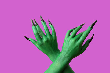 Green hands of witch on purple background. Halloween celebration