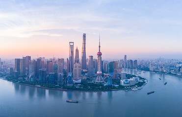 Aerial view of modern city skyline and buildings at sunrise in Shanghai.