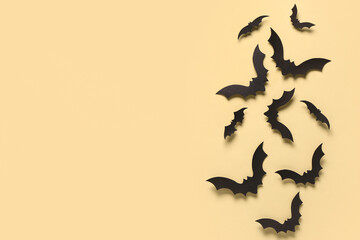 Paper bats for Halloween party on yellow background