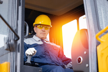 Man builder operate crane or excavator at construction site