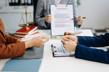 Lawyer refusing bribe money in the envelop from business man at lawyer office.