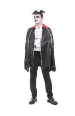 Young man dressed for Halloween as vampire on white background