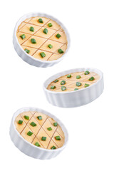 Asian steamed eggs in a bowl with soy sauce and scallions on a white isolated background