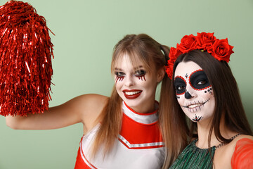 Obraz premium Female friends dressed for Halloween on green background, closeup