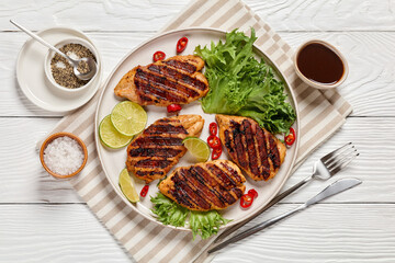 grilled chicken breasts wrapped in bacon on plate