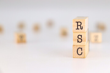 Corporate Social Responsibility acronym. RSC acronym on spanish language written on wooden cubes isolated on white background with copy space for text.