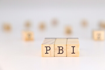 PBI letters - Gross Domestic Product in Spanish language written on wooden cubes isolated on white background with copy space for the text