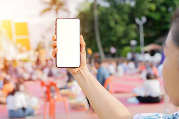 Close-up image of male hands holding smartphone with isolate screen at city shopping