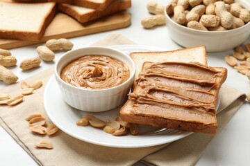Delicious sandwich with peanut butter and fresh nuts on table, closeup