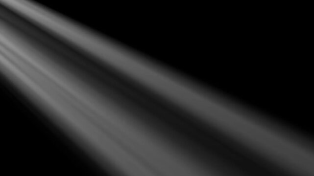 White rays of light from a window on a black background glow from the left side of the frame. Seamless animation of rays of light. Isolated animation of rays of white light. Looping animation of light