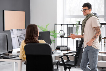 Male programmer working with his girlfriend in office